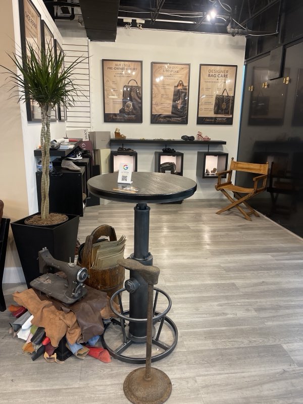 Workbench with leather hides and vintage tools inside the shop