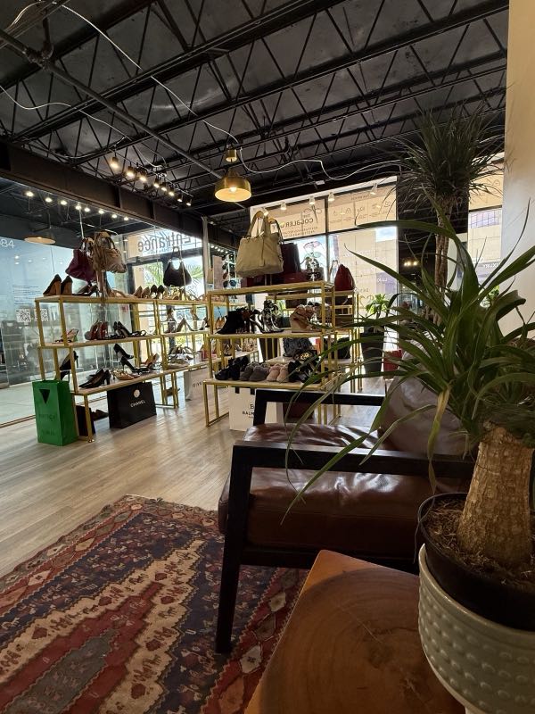 Designer handbags and heels displayed in the upscale showroom