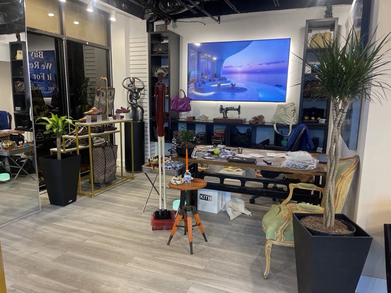 Wall of service displays for shoe repair, sneaker revival, and designer bag care